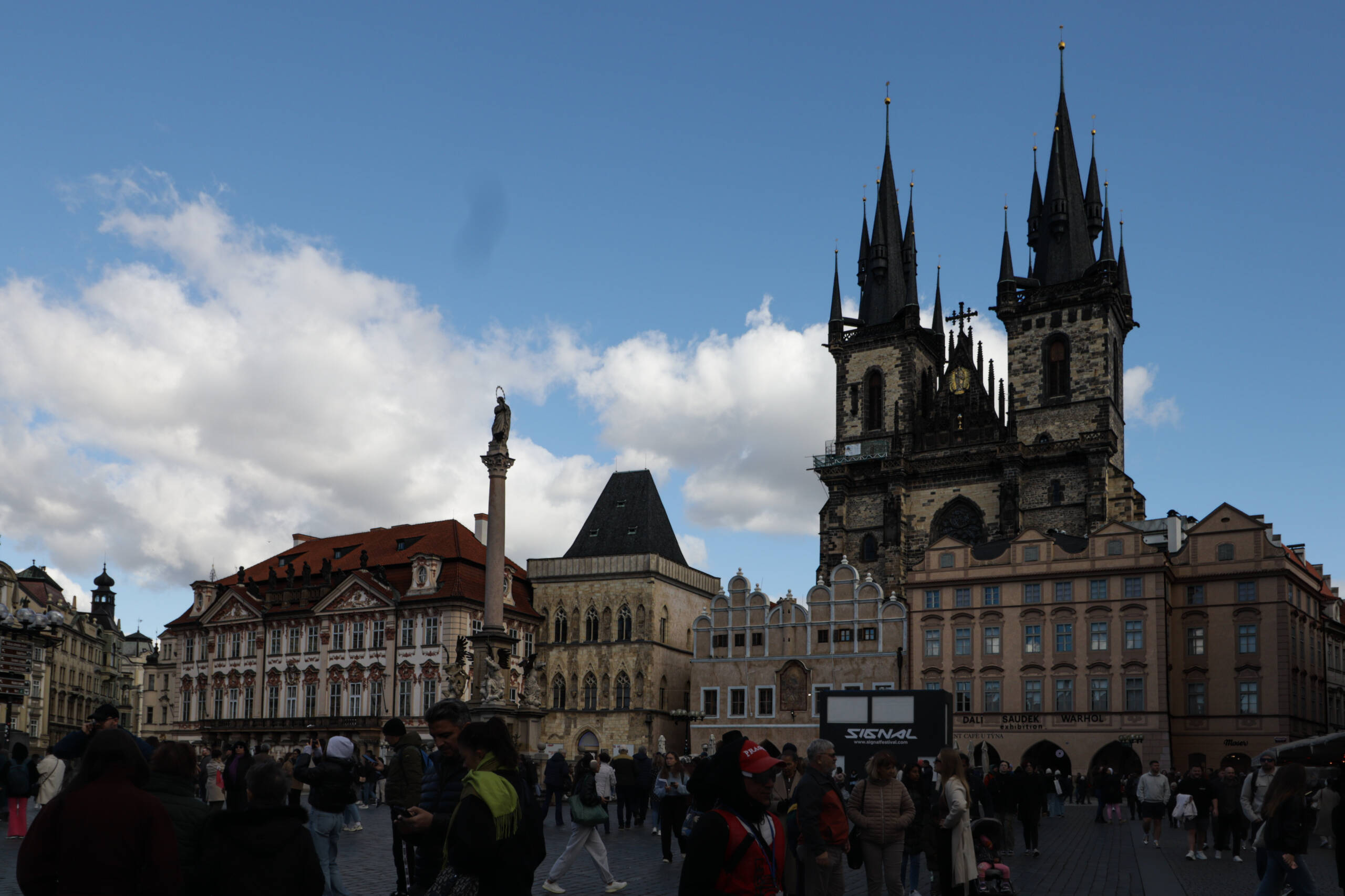 Old Town Square in Prague, the Týn Church in silhouette against a bright sky