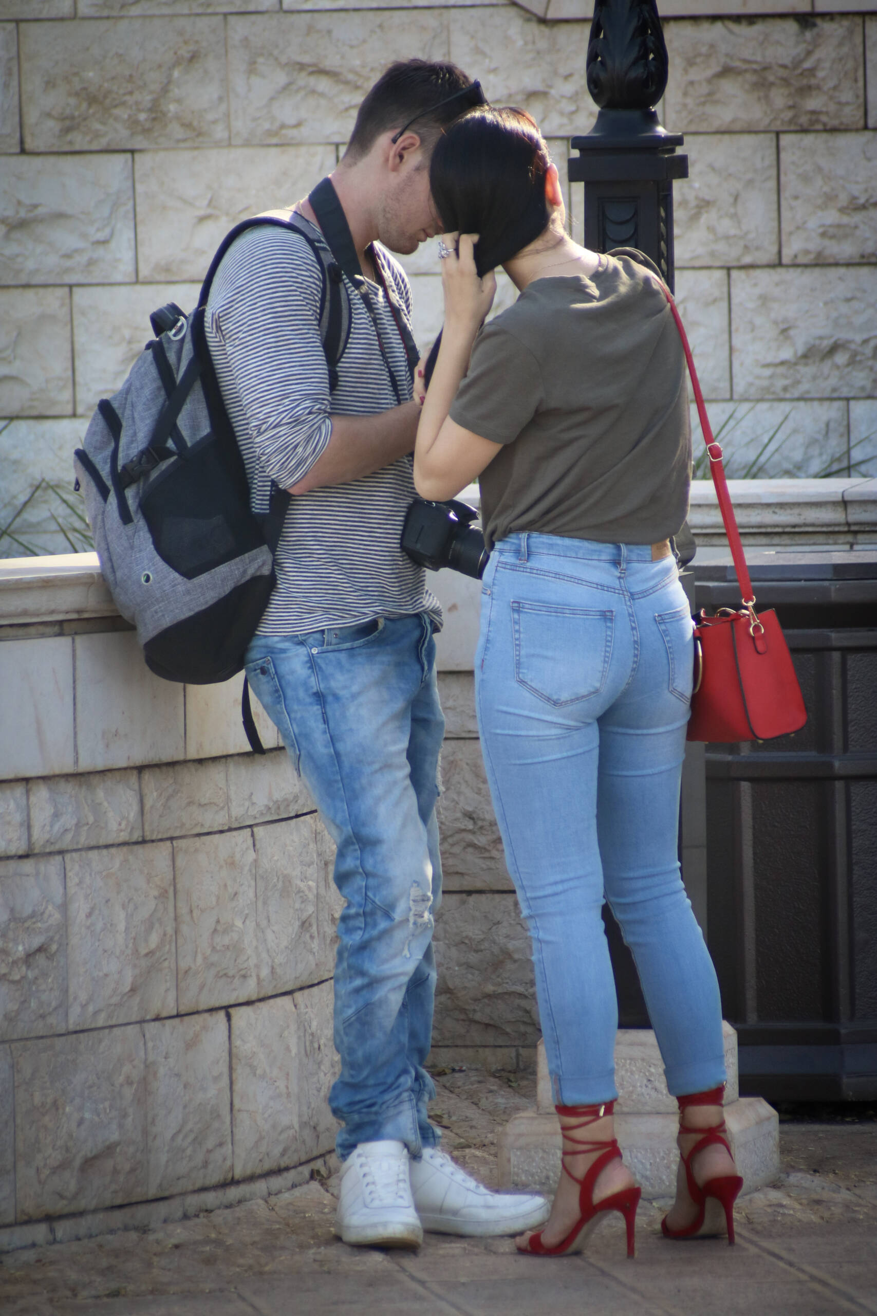 Street style look with red strappy sandals and a red mini bag